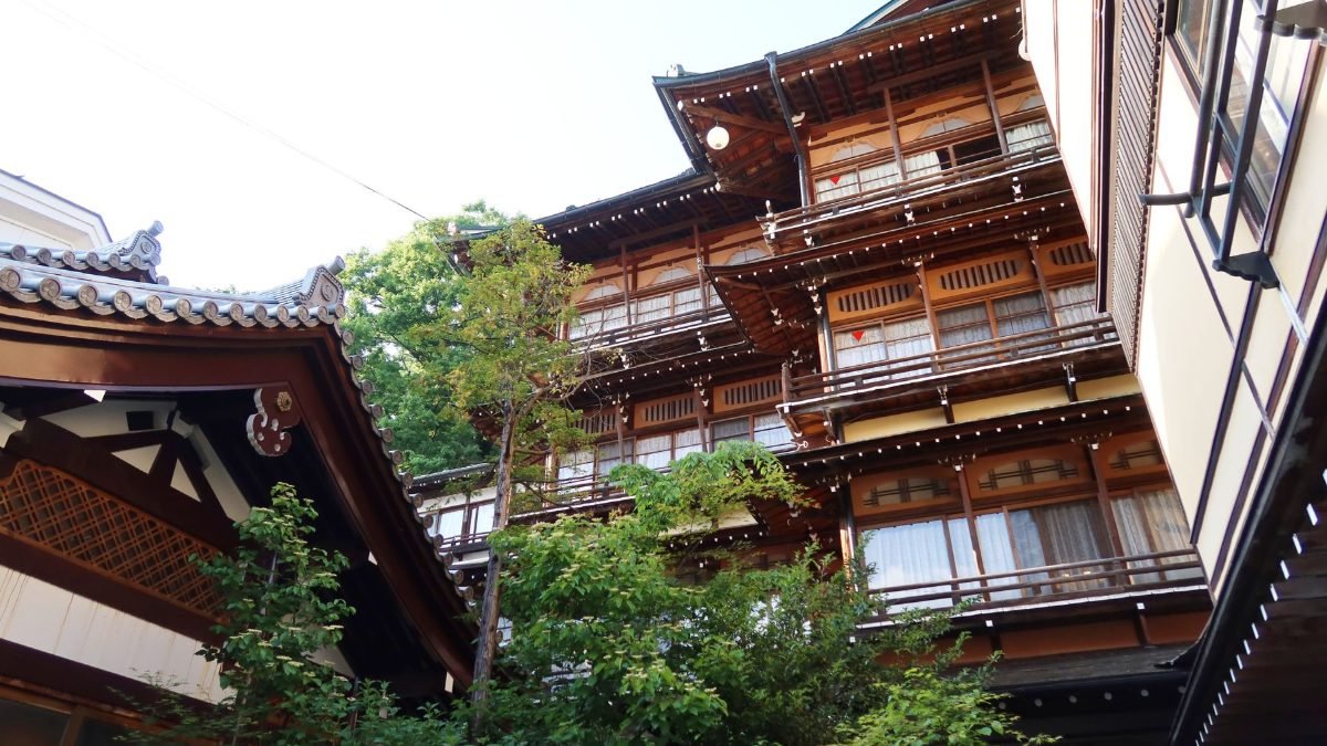 Traditional Japanese ryokan inn surrounded by greenery